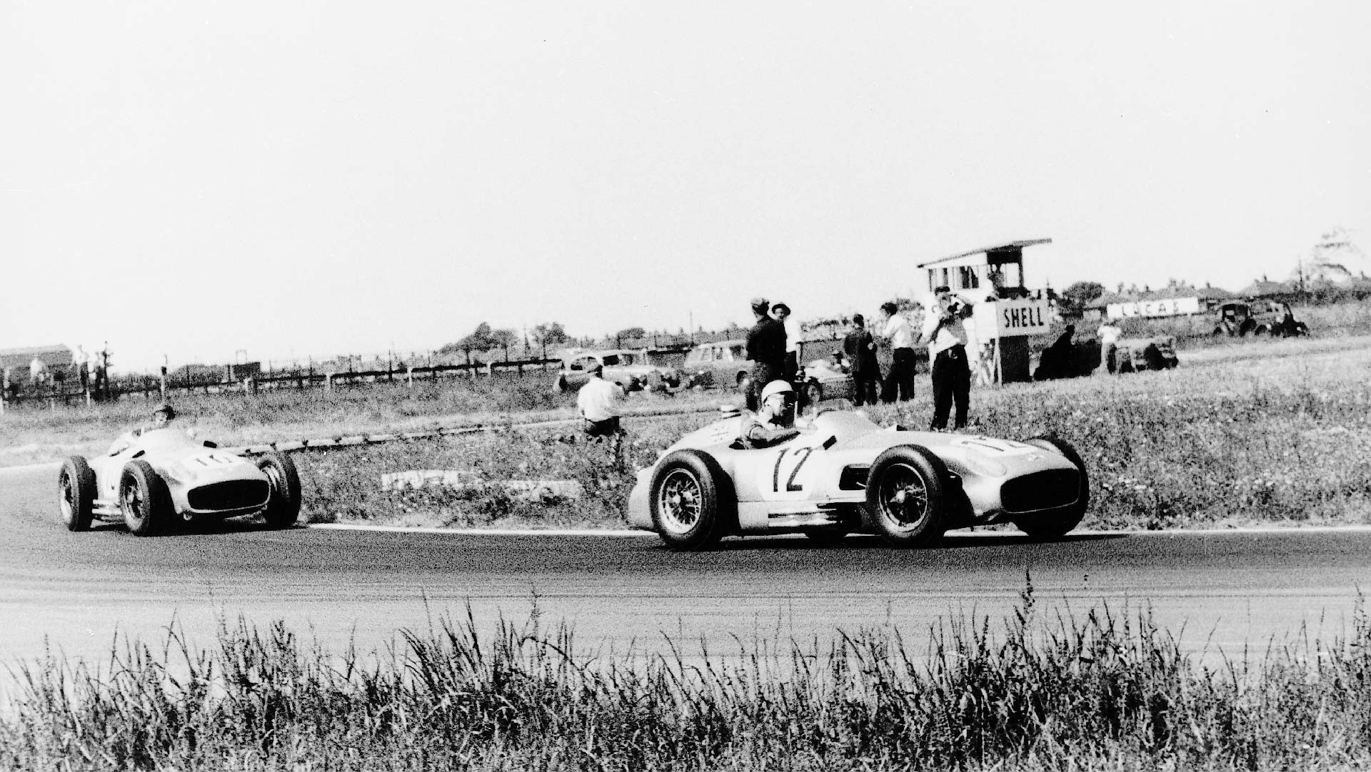 Stirling Moss leads Mercedes team mate Juan Manuel Fangio in the 1955 British GP